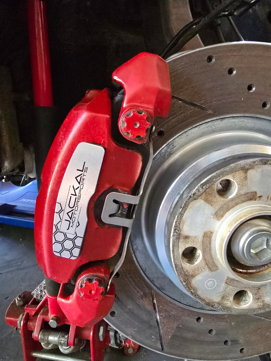 Brushed aluminum Jackal Motorsports brake face plate installed on Audi caliper