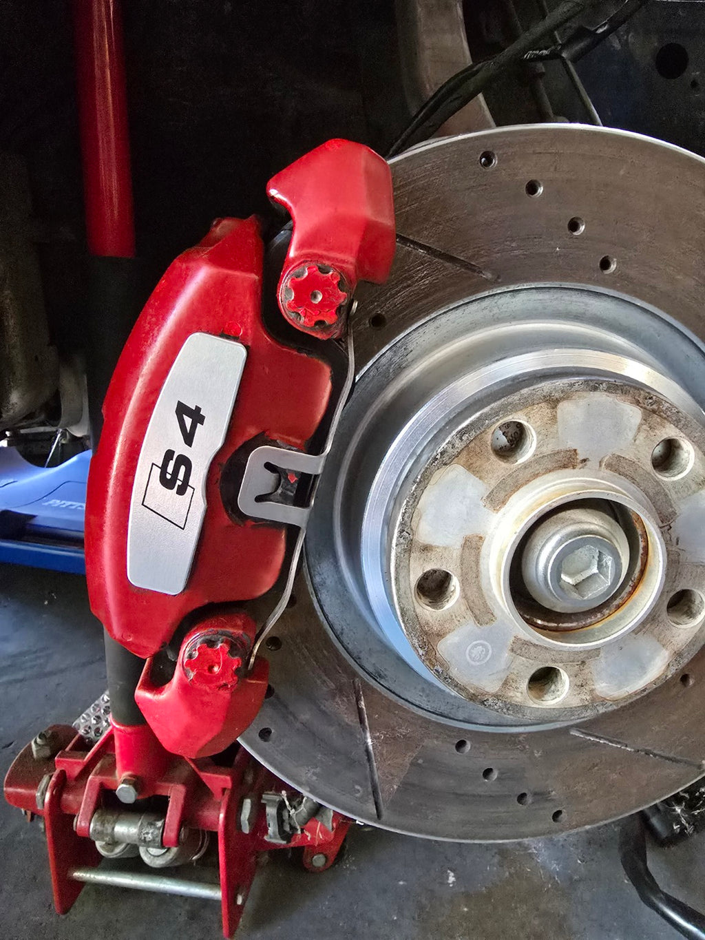 Brushed aluminum S4 brake face plate installed on Audi caliper
