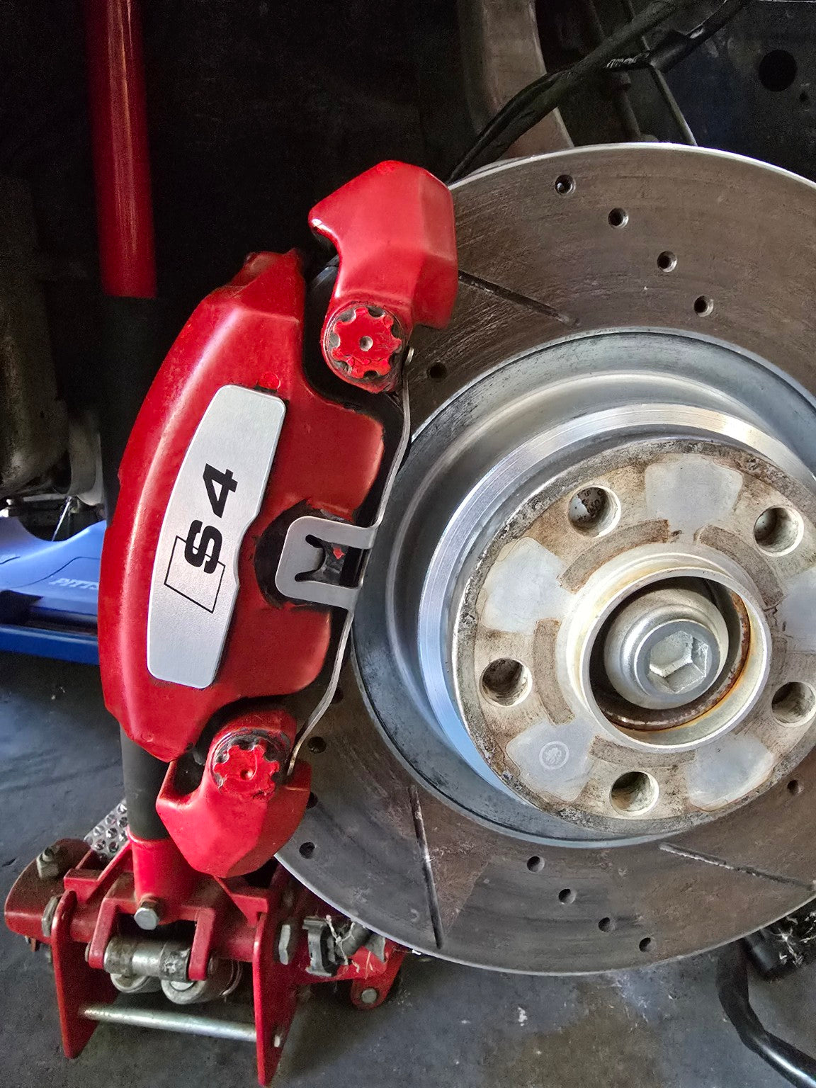 Brushed aluminum S4 brake face plate installed on Audi caliper